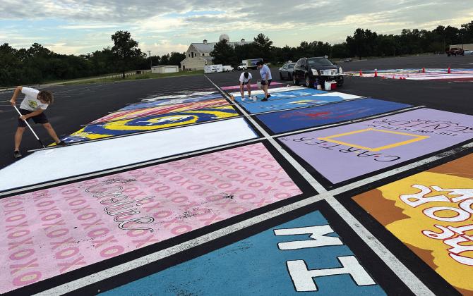 Sulphur Springs High School seniors enjoy one of the perks of being upperclassmen, the tradition of personalizing with paint their designated parking space in the student parking lot. Staff photo by Faith Whittle