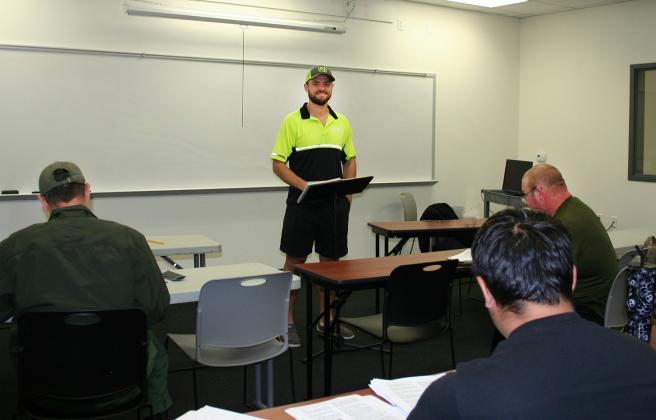 Commercial Driver's License Instructor Colin Ashbreck, standing, lectures a class of future truck drivers at the Paris Junior College-Sulphur Springs Center campus. CDL training includes classroom work and then driving lessons. PJC Information Services Photo