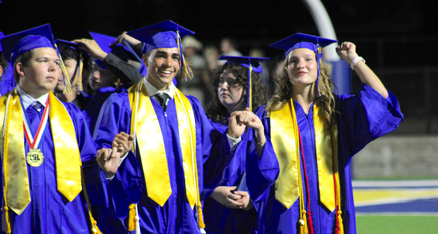 Grayson Wall, Creed Whisenhunt and Abbey Williams join pinkies and sing the school song one last time after receiving their diplomas during the Sulphur Springs High School commencement exercise Friday on the field at Gerald Prim Stadium. See page 2 for more photos. Staff photo by Lexi Delarosa