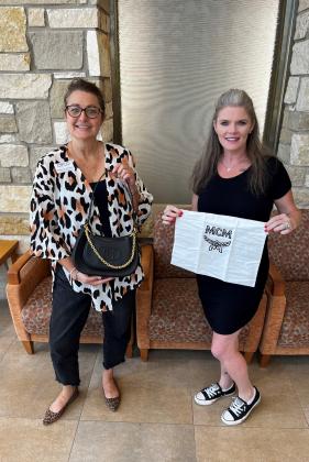 Sunny Springs Nursing &amp; Rehab is bringing smiles and a sleek bag to Designer Handbag Bingo. Stephanie Stephens and Amanda Yarbrough show off the MCM handbag which will be a prize at the annual bingo event hosted by the Hopkins County Health Care Foundation. Hopkins County Health Care Foundation photos
