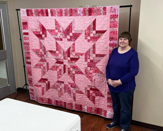 Quilter Linda Taylor displays her breast cancer quilt. Pink Power, as the quilt is named, will be auctioned off as part of the silent auction at Hopkins County Healthcare Foundation’s Gala to benefit In My Closet’s programs for local breast cancer patients and survivors. Visit LOLGala2024.GiveSmart.com for more information.