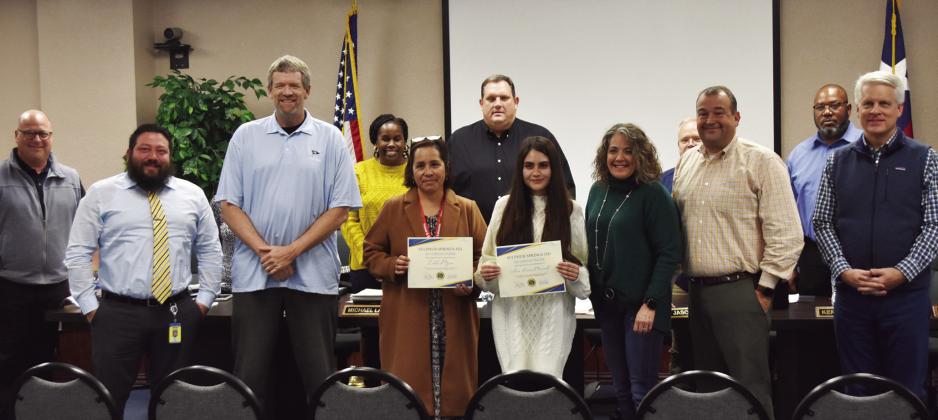SPECIAL AWARD — Sulphur Springs teachers Lidia Mejia and Anna Karen Miranda (center) stand with ESL Director Craig Toney and other school officials. Mejia and Miranda were honored with exemplary awards for their work with the bilingual and ESL program at Travis Elementary, looking on are school officials and trustees.