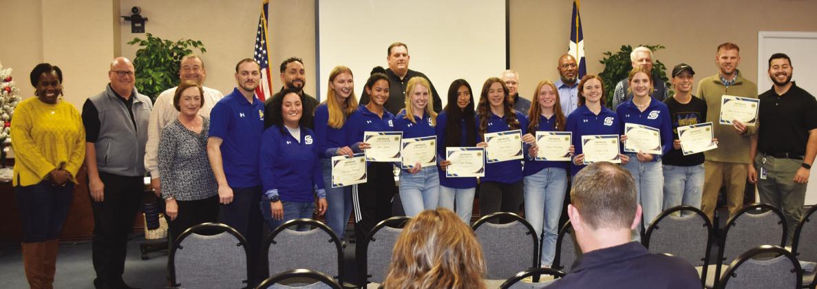 SPECIAL HONOR - The Sulphur Springs Cross Country team advanced to state for the first time in school history. They are shown with coaches and school board members at the recent trustees meeting.