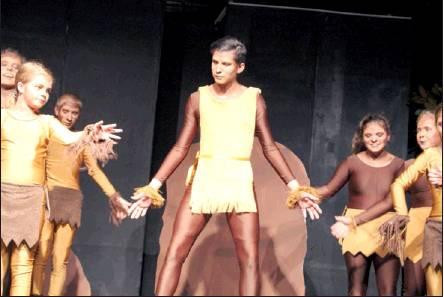 Caleb Talmage as Chief Monkey leads his monkey crew in a dance.