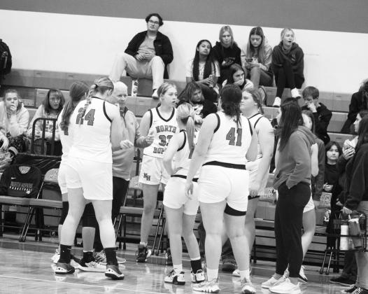 The North Hopkins Lady Panthers discuss their game plan during recent action. The Lady Panthers lost their Dec. 27 game against the Rivercrest Lady Rebels 50-43. Photo by DJ Spencer
