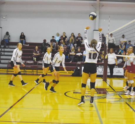 Cumby’s Erin Morgan sets a pass for Ashlyn Hudson in recent action. Morgan and Hudson both helped lead the Lady Trojans to a win over Greenville Christian Friday, as Morgan had 18 assists, 11 digs and six kills, while Hudson had eight kills and four blocks. Staff photo by Tyler Lennon