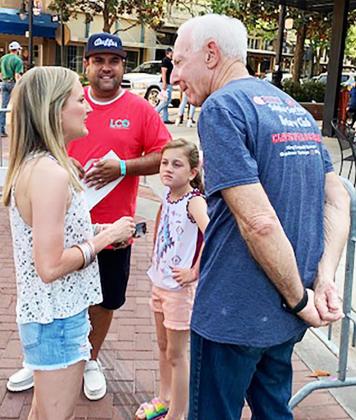 Hopkins County Judge Robert Newsom talks to people who were downtown Saturday at the Rotary's "Claws For A Cause" fundraiser. Staff photo by Dave Shabaz