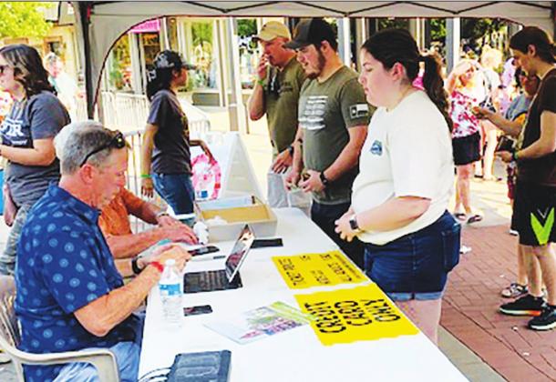 Saturday participants in the "Claws For A Cause" cookout downtown sign up at the event held by the Rotary Club of Sulphur Springs.