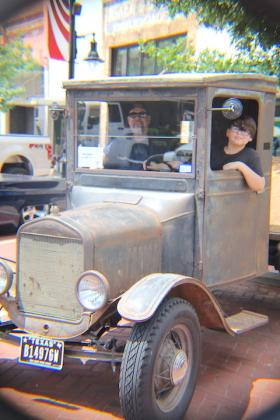 Duke Jones (left) and his son, Giorgio Lopez Jones, 11, of Sulphur Springs check out Randy Pendleton’s (not pictured) 1926 Ford TT at Saturday’s 22-mile Cruise & Car Show held in downtown Sulphur Springs.