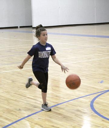 Abi Allen races to the finish during a dribble relay at the Ladycat Basketball Camp. Day one of the camp focused on ball movement while day two on Tuesday was slated to cover shooting drills.