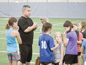 Sulphur Springs softball coach David Carillo gives instruction during the annual Ladycat Softball Camp, held June 10-12. Staff photos by Quinten Boyd