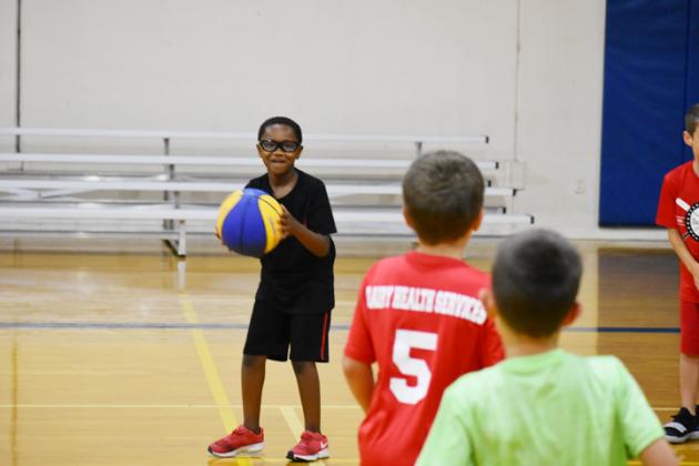 Jaze Smith scans the court before making a pass during day two of the Wildcat Basketball Camp.