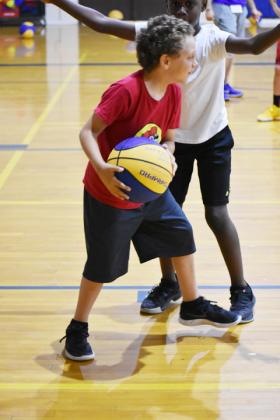 Kinsler Page (with ball) tries to get around the defense of Dewayne Ross during a drill at the annual Sulphur Springs Wildcat Basketball Camp, held Monday-Thursday.