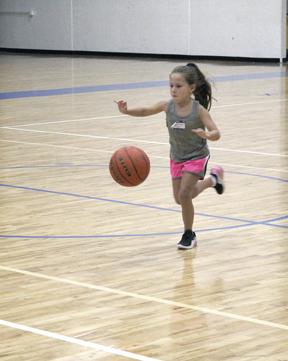Maebry Mitchell practices her dribbling skills during day one of the Ladycat Basketball Camp. 