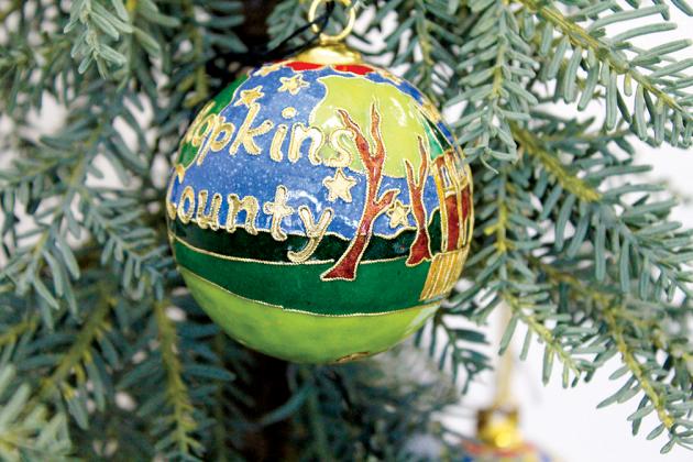The Hopkins County Chamber of Commerce has commissioned a limited edition set of 50 Hopkins County-themed, hand-painted, shatter-proof, 24k gold-trimmed, cloissoine Christmas ornaments available for sale. Staff photo by Tammy Vinson