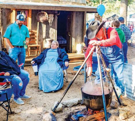 The Rock Creek Health & Rehab stew cooking team dressed in period costumes and decorated their stew site in Buford Park at the 2018 Hopkins County Stew Contest. Archive