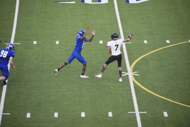 Devon Franklin (left) of Sulphur Springs puts defensive pressure on Forney junior varsity quarterback Noah Garcia, who had two touchdown passes in the game. Franklin had an outstanding game as well with several tackles and a forced fumble.