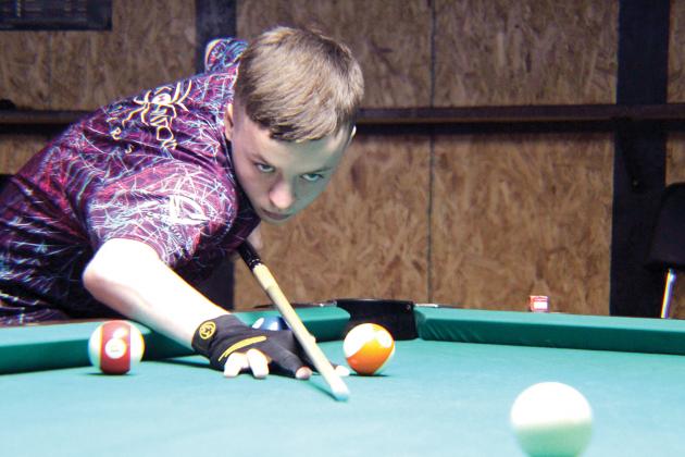 Cameron Cummings demonstrates intense concentration during a practice session at Rack and Break in Sulphur Springs ahead of his trip to Cyprus near Greece for the World Junior 9-Ball Championships. Staff photo by Tammy Vinson