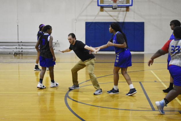 Lady Cat assistant basketball coach Bryan Jones gives tips to Sulphur Springs players during Wednesday practice at the high school gym. Jones is a former assistant coach at Saltillo who is a new member of the coaching staff along with Katie Webster under head coach Brittany Tisdell.