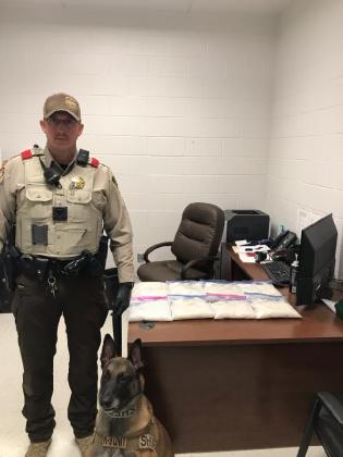 HCSO interdiction officer and K-9 officer Chiv pose with the 8 pounds of methamphetamine seized in a traffic stop on Interstate 30 east early Thursday morning. Courtesy/Sheriff Lewis Tatum