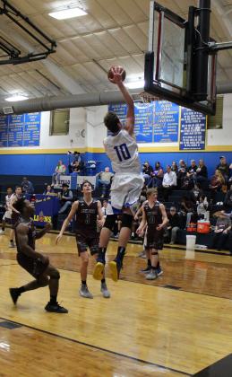 Chris Boekhorst on the receiving end of an alley-oop Tuesday night against Avinger. Staff photo by Tyler Lennon