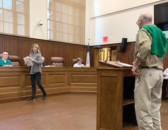 Carrie Chase Nuckolls hands out planning materials to the Zoning Board of Adjustments at Tuesday’s meeting. Staff photo by Taylor Nye