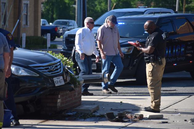 SSPD officer Jamieson Hawkins, city manager Marc Maxwell and airport/tourism director Joey Baker survey the damage from an early morning car chase at the Square