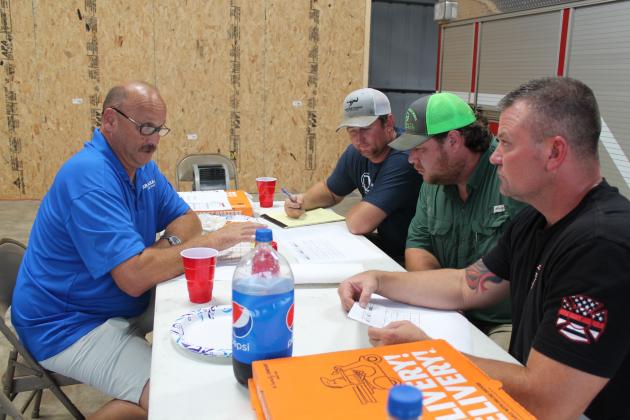 From left: Brinker's Carl Nix, Pickton-Pine Forest's Trey Thompson, Miller Grove's Ray Sparks and Arbala's Brian Fairchild review spreadsheets for a different dispatching system they believe will better help them respond to the rural nature of the county/ Staff photo by Taylor Nye