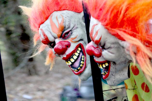 Creepy clown Kambree Davis is one of the colorful characters visitors might encounter along the "Woods of the Dead" haunted trail. Staff photo by Jillian Smith