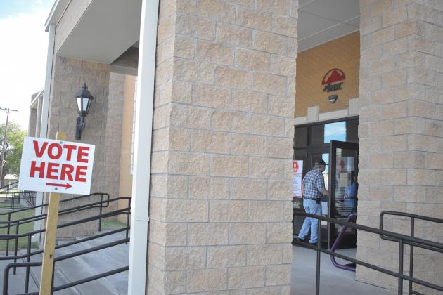 People walk into the ROC at 115 Putman St. on the first day of early voting in Texas. Early voting ends Oct. 30.