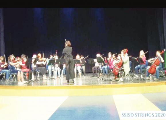 Sulphur Springs Middle School beginner orchestra, conducted by Kirby, performs "Jingle Bells." Screenshot