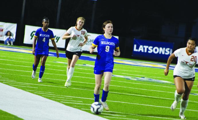 Senior Haylee Shultz (9) moves the ball down the pitch during the Lady Wildcats' game against Dallas White Friday. In her senior night game, Shultz was one of three Lady Wildcats to score a goal in their 4-0 victory. Photo by DJ Spencer
