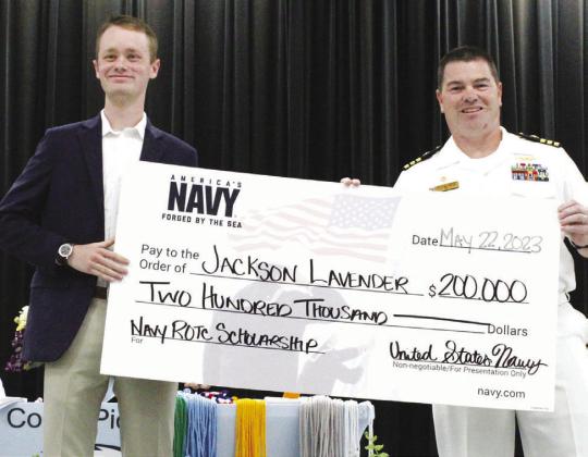 AWARD GIVEN — Jackson Lavender (left) receives a check for $200,000 ROTC scholarship from the United States Navy in the Monday awards assembly. Staff photo by Faith Huffman