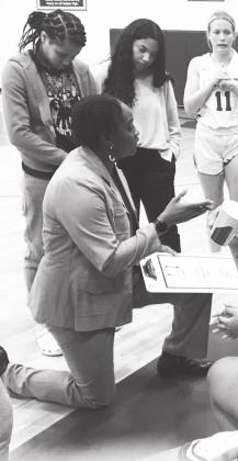 Erica Delley talks with the Lady Cats during a time out at recent home game. Delley is in her first season coaching at Sulphur Springs, she formerly was the head coach at Greeenville.