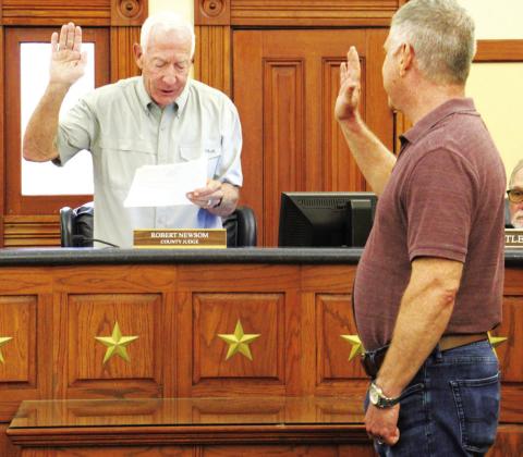 Hopkins County Judge Robert Newsom administers the oath of office of county health authority to Dr. Darrel G. Pierce. This will be Pierce’s second full term in the role. Staff Photo by Tammy Vinson