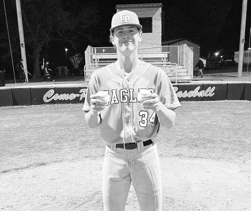 Dane Oud (34) proudly shows off his two home run balls from the Commerce game Tuesday. Oud batted 4/6, recorded seven RBIs, and scored six runs in the Eagles' 2415 extra innings loss Tuesday. Courtesy/Como-Pickton CISD
