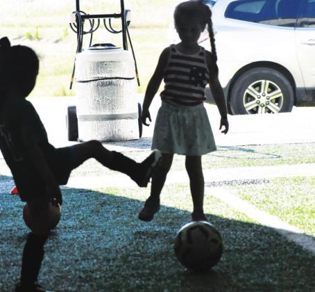 Even in the shadows on the side of the field, two little girls work on their soccer skills out of the bright summer sun. The Sulphur Springs soccer camp, which concluded Wednesday, had more than 150 participants each evening.