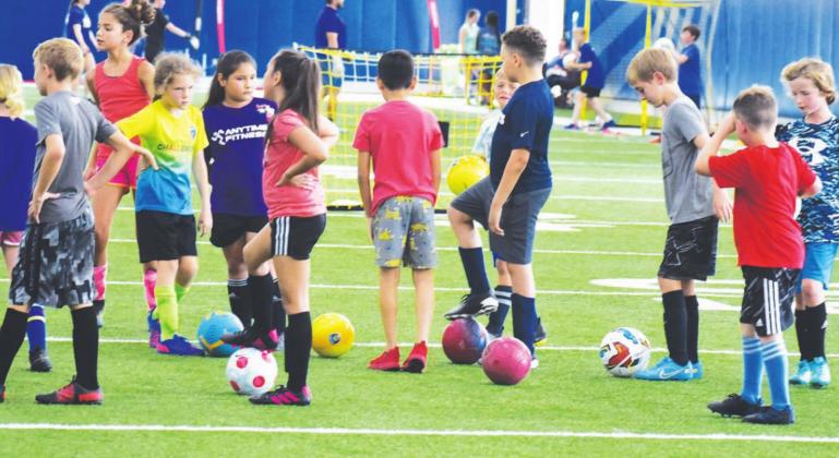 Soccer players take a rest while they wait to move into another drill at the Sulphur Springs soccer camp held recently at Sulphur Springs High School.