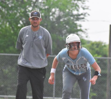 Trevor Wallace prepares to send Addi Monk (7) home during a game against Rivercrest this past season. The Lady Eagles won that game 10-0 and Wallace earned his 100th victory during that same game. Photo by DJ Spencer