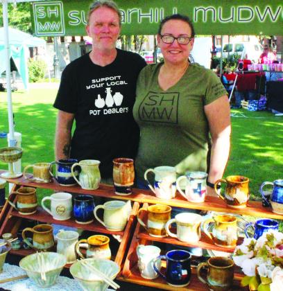 Jeremy Haynes and Stacey Tafoya showcase their handmade pottery downtown at the Hopkins County Farmer’s Market on Saturday. Their business, Sugarhill Mudworks Ceramic Studio, is located in Mount Vernon and online at ‘sugarhillmudworks.com.’