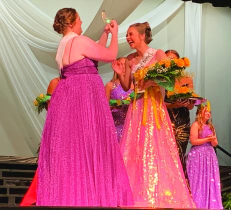 BIG MOMENT — Colbie Glenn, 2022 Dairy Festival Queen, unpins the crown from her hair and places it atop Caroline Prickette’s, officially passing the torch of local pageant royalty to her. More photos on page 14. Staff photo by Faith Huffman