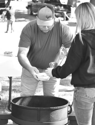Bobby Neal ladles chili into a bowl for a hungry attendee of the Help-A-Child Benefit Saturday at the Civic Center. It was Neal's first time participating in the annual chili cook-off since he usually cooks stew at the Hopkins County Stew Contest. Neal's chili managed to take first place this year. Staff photo by Todd Kleiboer