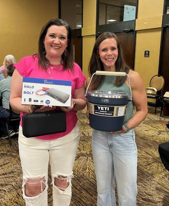 Alyssa Flatt (left) and Whitney Vaughan pose with a couple of the first-round prizes for Mingo. HCHC Foundation photos
