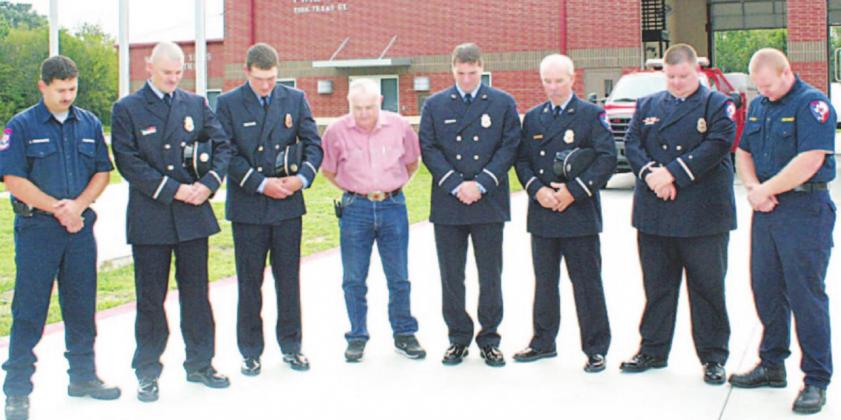 In 2007, commissioner Don Patterson (fourth from left) joins Hopkins County firefighters (left to right) Forest Densmore, Brian Fairchild, Caleb Melton, Andy Endsley, Herb Scott, Michael Matthews and Josh Ferrell as they all observe a moment of silence in remembrance of the 343 firefighters and others who died on Sept. 11, 2001, as a result of the terrorist attacks at the World Trade Center, Pentagon and Pennsylvania. Archive