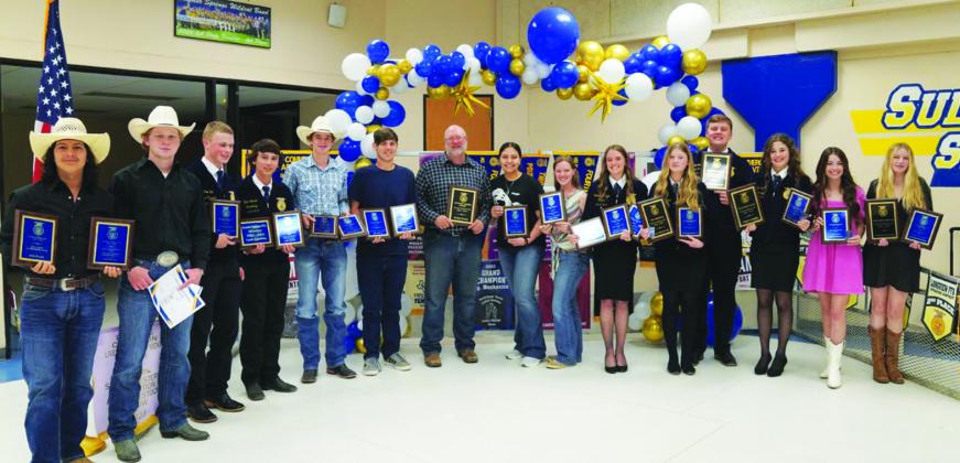 WINNING AWARDS — Members of the Sulphur Springs Future Farmers of America show awards won during the year.