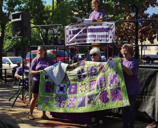 The raffle quilt, created in the colors of Terrific Tuesdays, was won by Karen Strickland. (Standing, left) Tammy Reardon, Karen Stricand and carolynPritchett