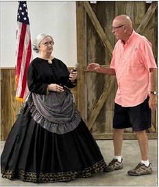 Rick Wilson, president of the Hopkins County Historical Society, introduces Paula Altenbaumer as Mary Ann Hargrave McLaughlin, a pioneer of 180 years ago.