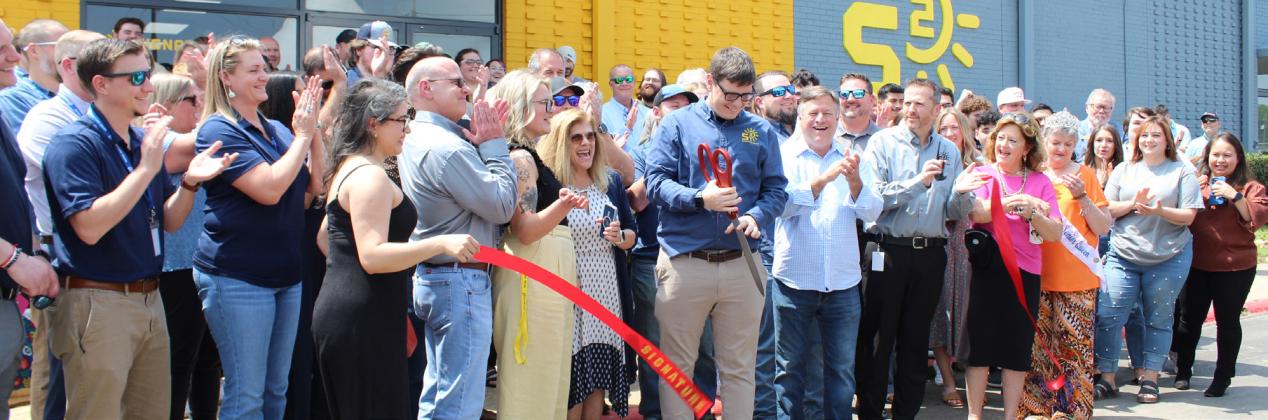 Signature Solar CEO James Showalter does the honors during the ribbon cutting for the opeing of its new facility on East Industrial Drive, which will open nearly 200 full-time team members.