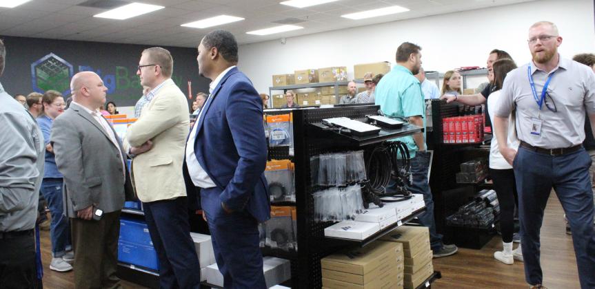 Signature Solar staff explain the many services and supplies available at the company's new Supply Store during the grand opening ceremony on May 1. The facilty is located at 421 East Industrial Drive.