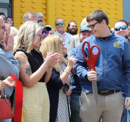 Signature Solar CEO James Showalter shares grins and receives well wishes following the official ribbon cutting during the grand opening for the company's Sulphur Springs Supply Store, Distribution Center and Design Center.